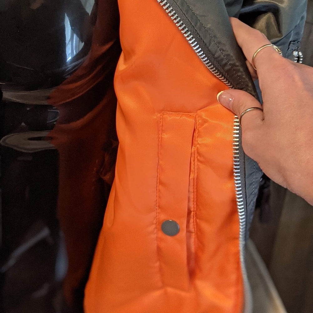 Gray jacket with orange liner. New